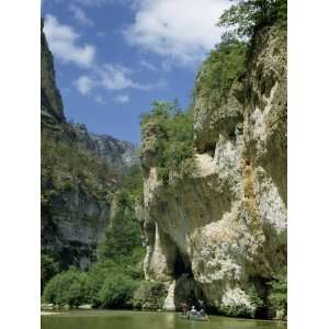 Men in a Boat Drift Downriver Between Steep Limestone Cliffs Stretched 