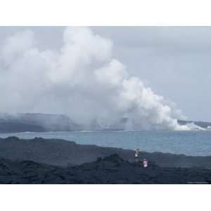 Steam Plumes from Hot Lava Flowing onto the Beach and Hitting the 