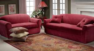 Red slipcovers dress up sofa and loveseat in living room