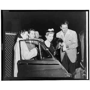  Barbara Hutton being helped into car by friends,1954