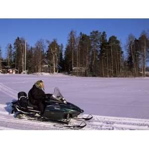 Woman Driving Snowmobile Near Lulea, Lapland, Sweden, Scandinavia 